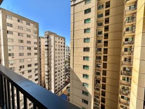 a view from a balcony of tall buildings at Apart St Bueno SuperKing Ar, Cozinha, Vaga in Goiânia +2 photos