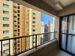 a balcony with a view of a tall building at Apart St Bueno SuperKing Ar, Cozinha, Vaga in Goiânia