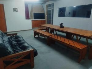 a living room with wooden tables and a couch at Villa sol in Córdoba