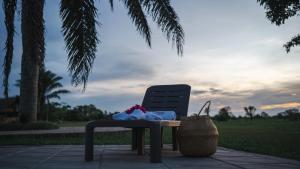 a chair sitting on a patio with a table and a basket at WISIRARE ECOLODGE - Luxury experience in Yopal