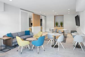 a lobby with a couch and tables and chairs at TownePlace Suites Pigeon Forge in Pigeon Forge
