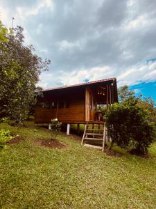 a log cabin with a staircase in the grass at La esmeralda in Arbeláez +17 photos