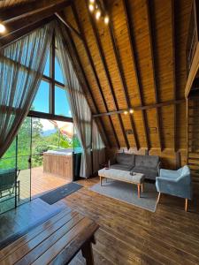 a living room with a couch and a table at Cabanas Nascer do Sol in Santo Amaro da Imperatriz