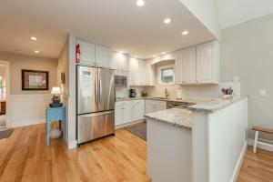a kitchen with white cabinets and a stainless steel refrigerator at Starry Night by Railey Vacations in Swanton +62 photos