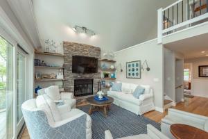 a living room with white furniture and a fireplace at Starry Night by Railey Vacations in Swanton