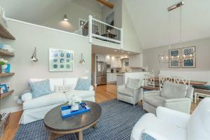 a living room with white furniture and a table at Starry Night by Railey Vacations in Swanton