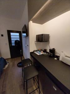 a room with a kitchen with a counter and a microwave at Dormi km3 in Comodoro Rivadavia +2 photos