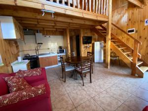 a living room with a dining room table and a kitchen at Cabañas Antonia in Futaleufú +36 photos