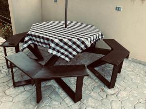 a table and two chairs with a checkered tablecloth on it at La esmeralda in Arbeláez