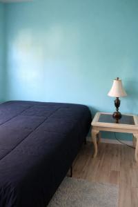 a bedroom with a bed and a table with a lamp at GpL 424 San Bernardino in North Fort Myers