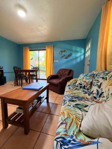 a living room with a couch and a table at Bohemian Monkey in Cahuita