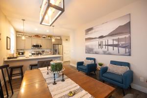 a living room with a dining room table and a kitchen at Sunflower Beach Cottage in Ocean Shores