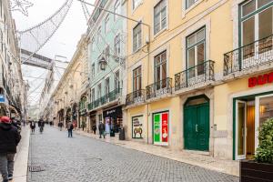 a cobblestone street in a city with buildings at Boutique duplex in Chiado with epic Rossio view in Lisbon