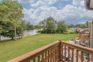 a balcony with a view of a yard and a river at Ski Harbor #32 by Railey Vacations in McHenry