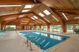 a large swimming pool in a building with wooden ceilings at Ski Harbor #32 by Railey Vacations in McHenry