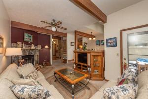 a living room with a couch and a table at Ski Harbor #21 by Railey Vacations in McHenry