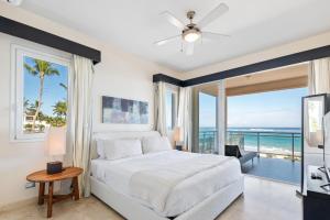 a bedroom with a bed and a view of the ocean at Watermark Luxury Oceanfront Residences in Cabarete +26 photos