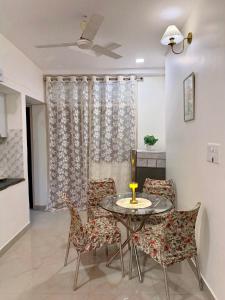 a dining room with a table and chairs at Heartistry in Jabalpur +9 photos