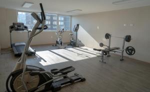 a gym with several exercise equipment in a room at DEPARTAMENTO ACOGEDOR Y TRANQUILO en Chillán Centro, full equipado, ideal para descansar, Wifi y Estacionamiento in Chillán