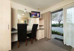 an office with a desk and a window and a desk and chair at Cranford Oak Motel in Christchurch