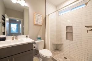 a bathroom with a toilet and a sink and a shower at Sunflower Beach Cottage in Ocean Shores +33 photos