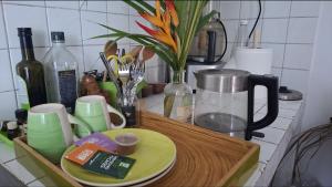 a kitchen counter with a tray with plates and cups at Comme à la maison! Le Moule in Le Moule