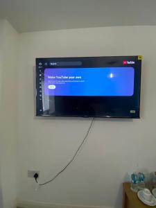 a flat screen tv hanging on a wall at Stay at LL in Doncaster