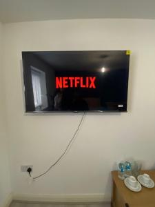 a television with a netflix sign on a wall at Stay at LL in Doncaster +1 photo