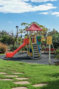 a playground with a slide in a park at Casa Foz da Ria in Lagos