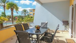 a balcony with a table and chairs and a view of the ocean at Casa Foz da Ria in Lagos