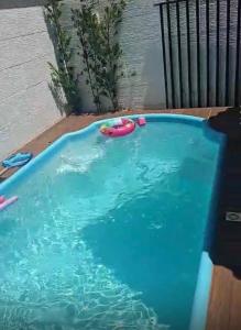 a swimming pool with a toy in the water at Aconchego in Cascavel