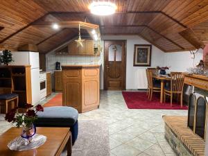 a kitchen and living room with a couch and a table at Elation Woodhouse in Elati +22 photos