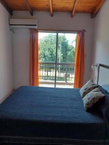 a bedroom with a bed and a large window at Tu Destino in San José