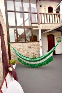 a hammock in the courtyard of a building at L Grace Centro in Búzios