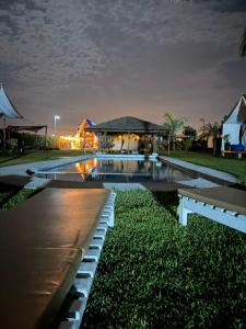 a swimming pool in front of a house at night at AMAY in Asia