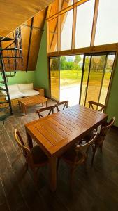 a wooden table and chairs in a room with windows at AMAY in Asia
