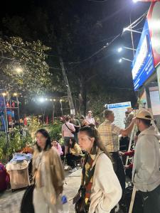 a group of people walking down a street at night at Lona Villa Tam Coc in Vũ Lâm