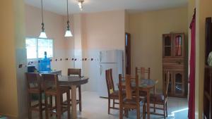 a kitchen with a table and chairs and a refrigerator at Suite Crucita in Crucita