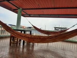 a hammock hanging from a roof in a building at Suite Crucita in Crucita +10 photos