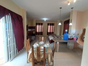 a dining room and living room with a table and chairs at Suite Crucita in Crucita