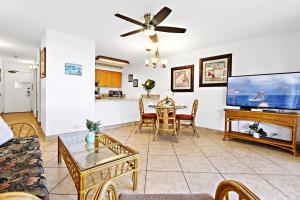 a living room with a couch and a tv at Paki Maui 326 in Kahana