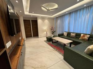 a living room with a couch and a table at Conifer heights in Shimla +18 photos