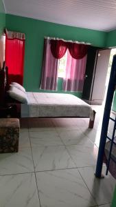 a bedroom with a bed in a room with a window at Hospedaje Tío Tom in Bernardo de Irigoyen
