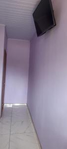 a white room with a flat screen tv on a wall at Hospedaje Tío Tom in Bernardo de Irigoyen