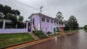 a purple house on the side of a street at Hospedaje Tío Tom in Bernardo de Irigoyen