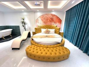 a bedroom with a large yellow bed and a bath tub at Love Hotel Hóc Môn in Ho Chi Minh City