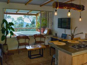a kitchen with a tub and a table and chairs at Green mount in Medellín