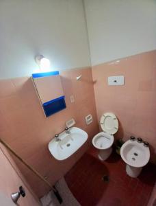 a bathroom with a sink and a toilet and a mirror at Casona Sol in Mar del Plata +41 photos