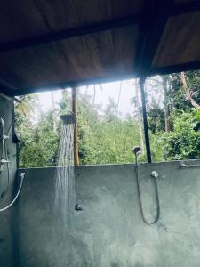 a shower with water coming out of it at Lake Cabana in Udawalawe