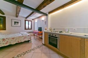 una cocina con fregadero y una cama en una habitación en In the heart of BIENNALE ac wi-fi, en Venecia